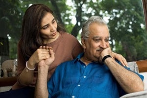 Caregiver comforts her aging father, coaxing him to open up to her