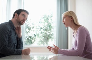 Young woman explaining to sheepish friend why unsolicited advice is unhelpful