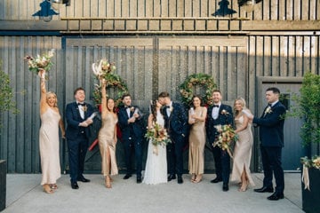 Cróna and Brendan (center) sharing kiss as bridal party celebrate