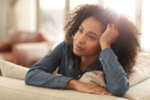 girl-laying-on-a-couch-thinking