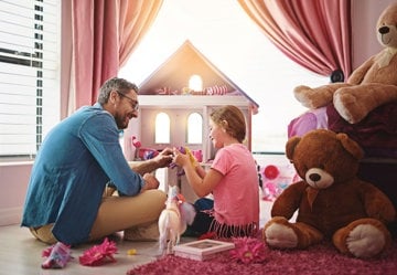 Man and daughter playing with dolls as a fun caregiving preparation activity