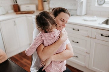 Relieved mother hugging her child to her chest