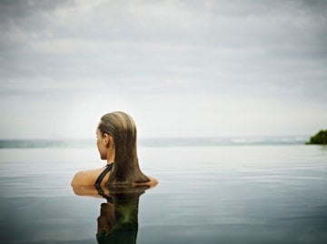 Woman bathing in open water, easing her back pain