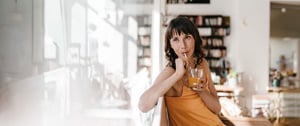 Woman with HD drinking with a straw to minimize the risk of choking 