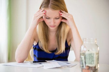 Woman looking over her finances, checking how much her asthma treatment has cost her this month