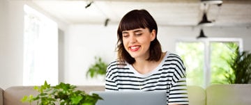 Woman smiling as she works at her own business from home 