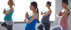 Woman with asthma enjoying a Pregnancy Yoga group exercise class