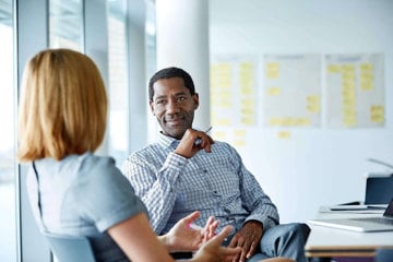 Woman with migraine explaining her condition to understanding boss