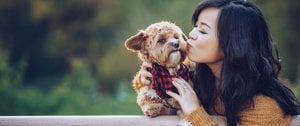 Kayla Butter kissing her dog