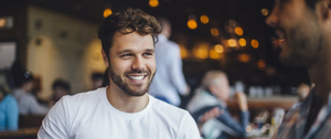 man smiling and drinking coffe