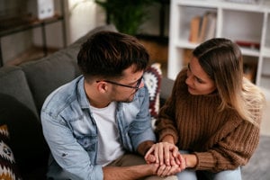 couple holding hands and talking