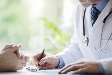 Doctor taking notes as patient asks about COPD