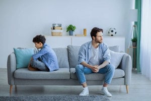 Father-And-Son-Sitting-On-A-Couch-Angry