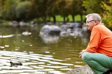 man-with-heart-failure-by-lake-reflecting-on-his-healthier-lifestyle-and-mindset