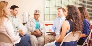 Support group sat in chairs talking about the stigma and patronizing language they face daily due to their disabilities