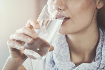 Woman ingests a migraine cocktail to help manage and reduce her pain