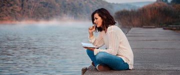 woman sitting by the lake